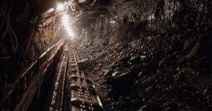 "Old coal mines tunnel with broken rocks and dim lights, look dark and empty inside"